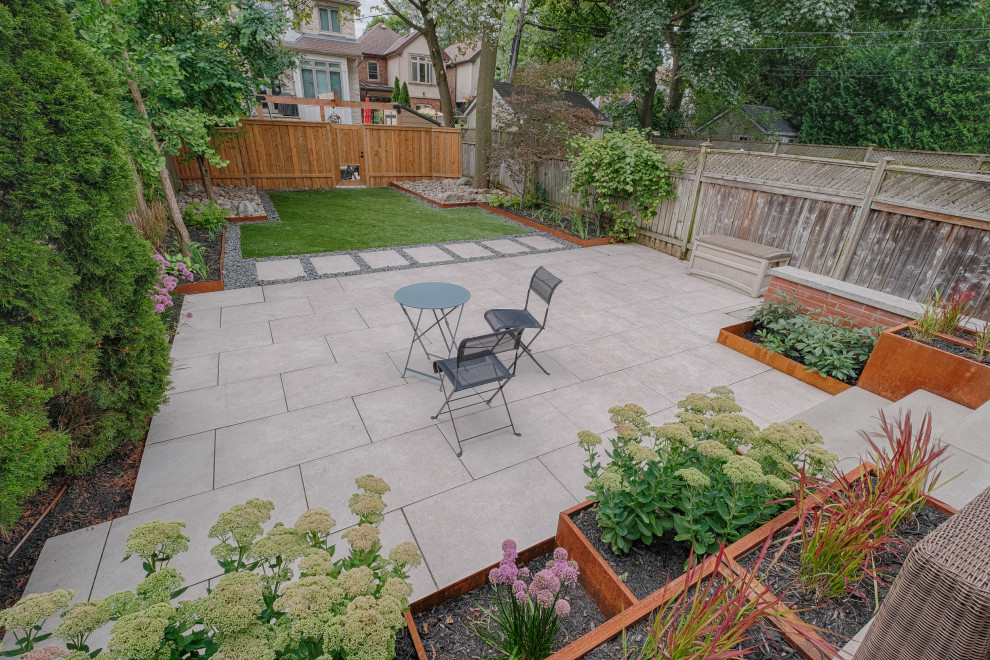 Photo of a small contemporary back patio in Toronto with a potted garden, tiled flooring and no cover.