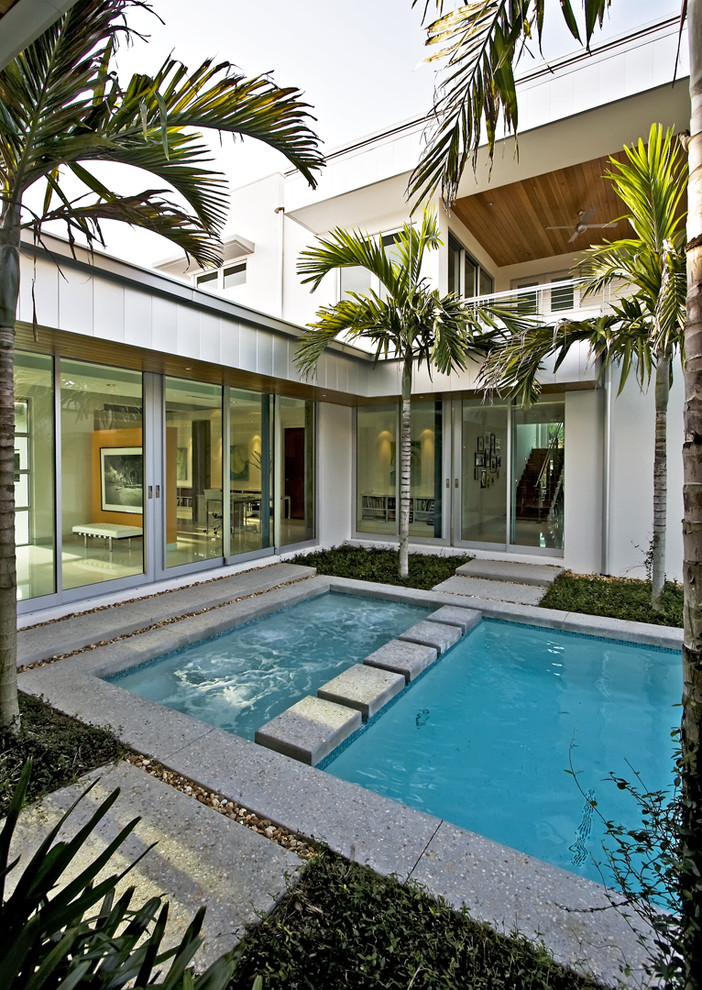 Design ideas for a small modern courtyard rectangular pool in Miami.