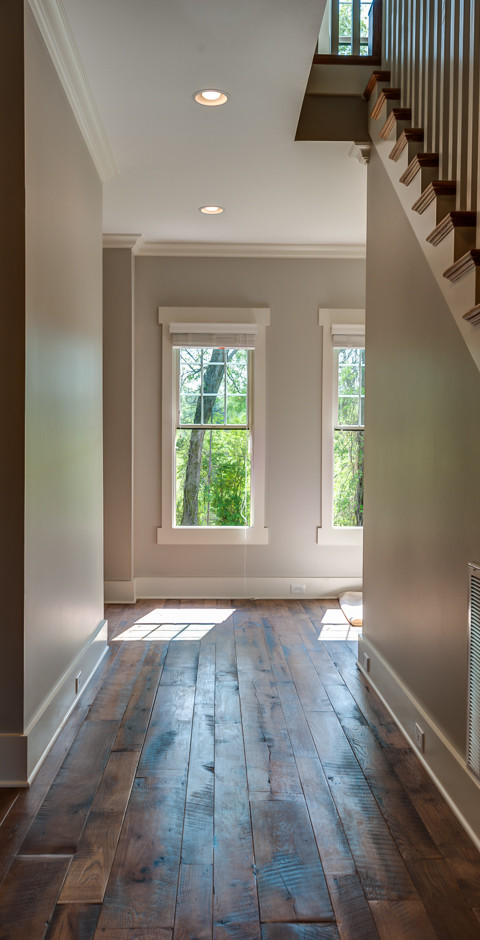 Design ideas for a mid-sized transitional hallway in Other with beige walls and dark hardwood floors.