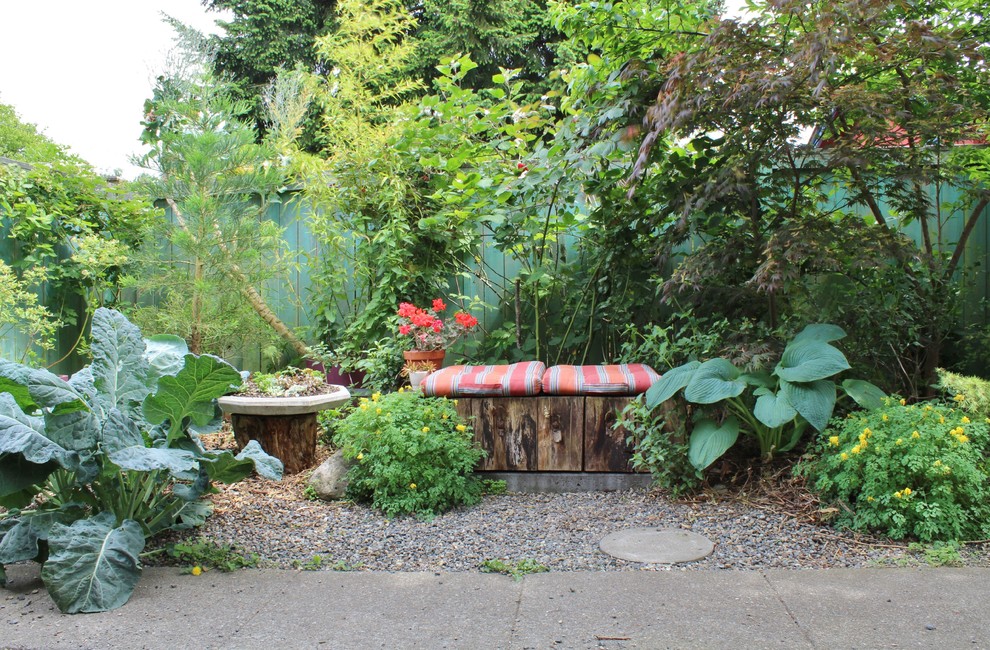 Photo of an eclectic backyard shaded garden with a vegetable garden.
