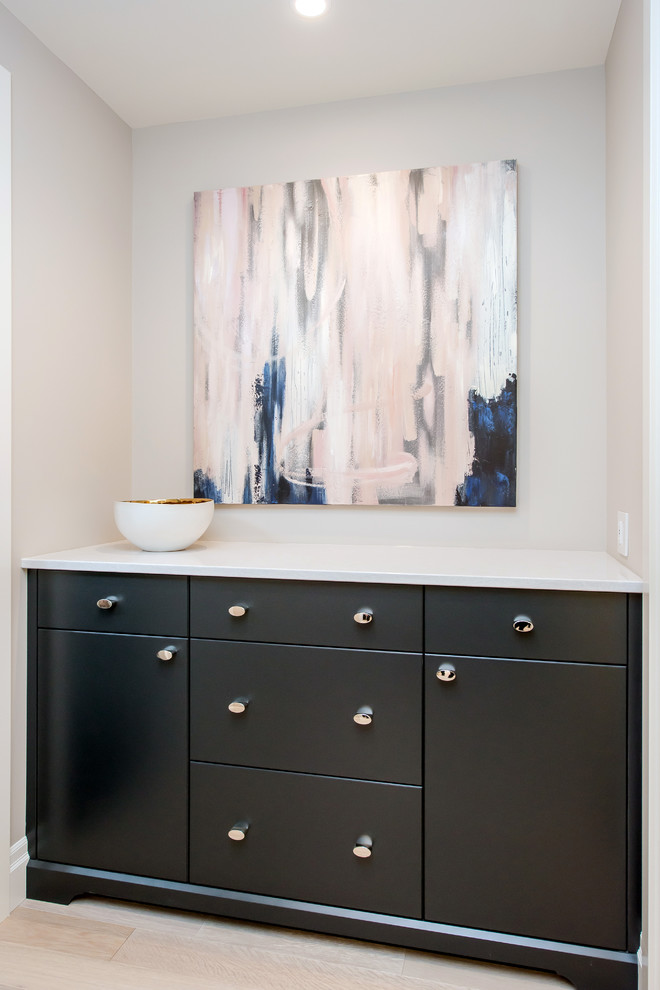 Entryway - mid-sized transitional light wood floor entryway idea in Calgary with gray walls