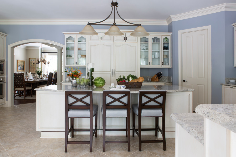 Inspiration for a large traditional kitchen in DC Metro with raised-panel cabinets, white cabinets, granite benchtops, with island, panelled appliances, ceramic floors and brown floor.