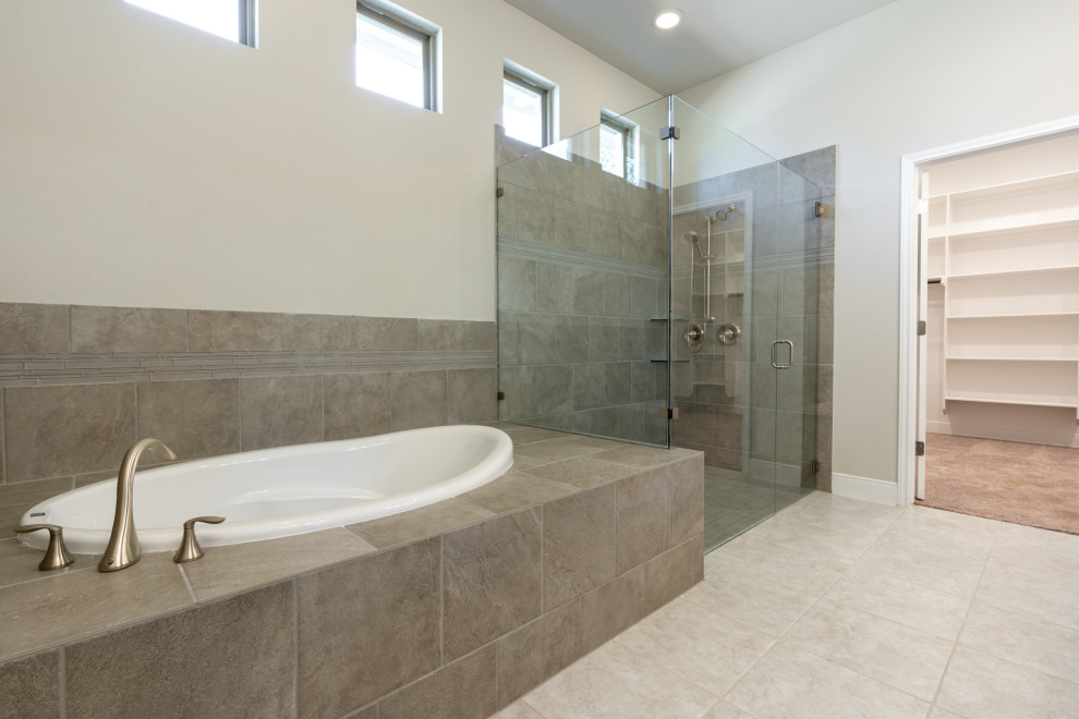 This is an example of a large arts and crafts master bathroom in Austin with recessed-panel cabinets, dark wood cabinets, an alcove tub, a double shower, a two-piece toilet, beige tile, ceramic tile, beige walls, ceramic floors, an undermount sink, granite benchtops, beige floor, a hinged shower door, white benchtops, an enclosed toilet, a double vanity and a built-in vanity.