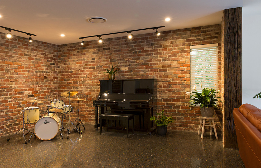 Industrial open concept family room in Brisbane with a music area, concrete floors, no fireplace and grey floor.