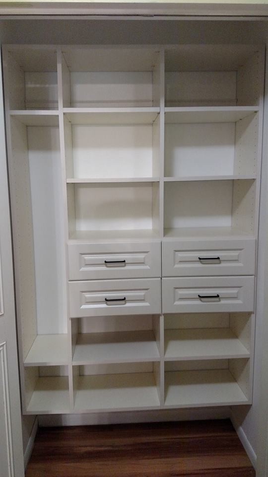 This is an example of a small contemporary built-in wardrobe in Other with raised-panel cabinets and beige cabinets.