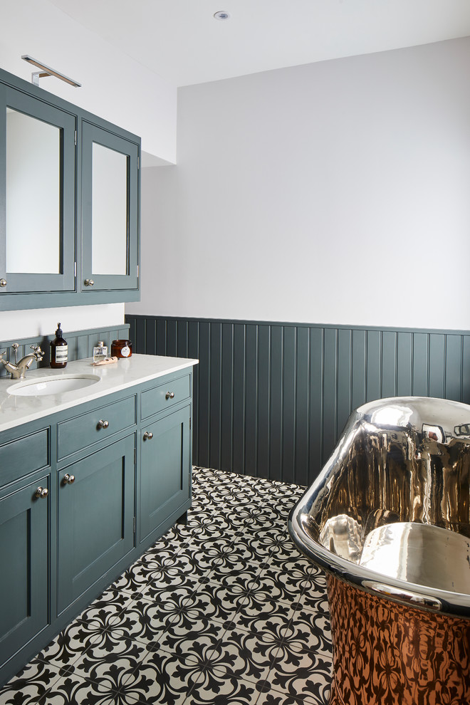 Inspiration for a small traditional kids bathroom in London with shaker cabinets, green cabinets, a freestanding tub, a shower/bathtub combo, a wall-mount toilet, grey walls, mosaic tile floors, a drop-in sink, quartzite benchtops, multi-coloured floor and grey benchtops.