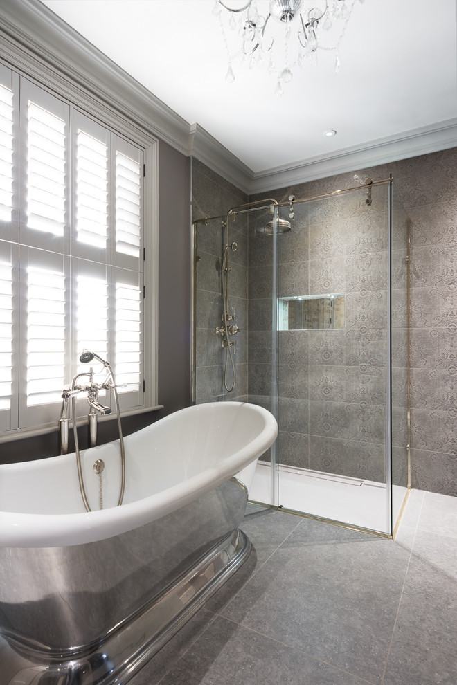 Transitional master bathroom in Kent with a freestanding tub, a curbless shower, gray tile, grey walls, grey floor and a sliding shower screen.
