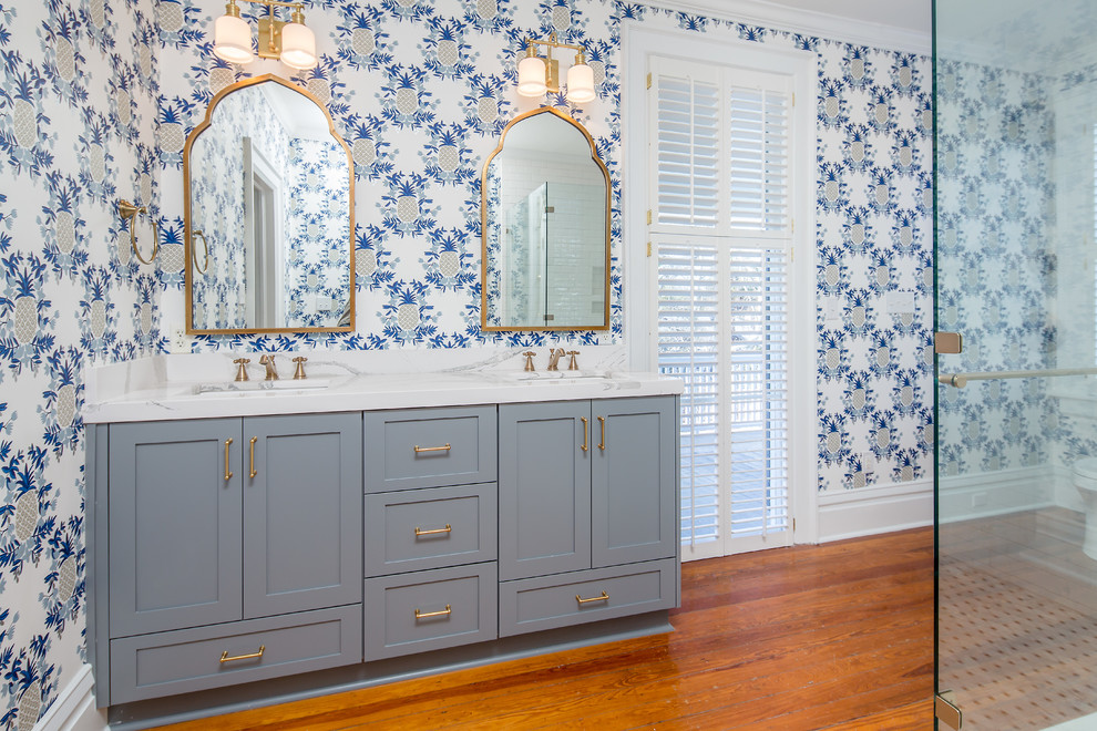 Inspiration for a mid-sized transitional master bathroom in Atlanta with shaker cabinets, grey cabinets, medium hardwood floors, an undermount sink, engineered quartz benchtops, blue walls, a one-piece toilet and a corner shower.