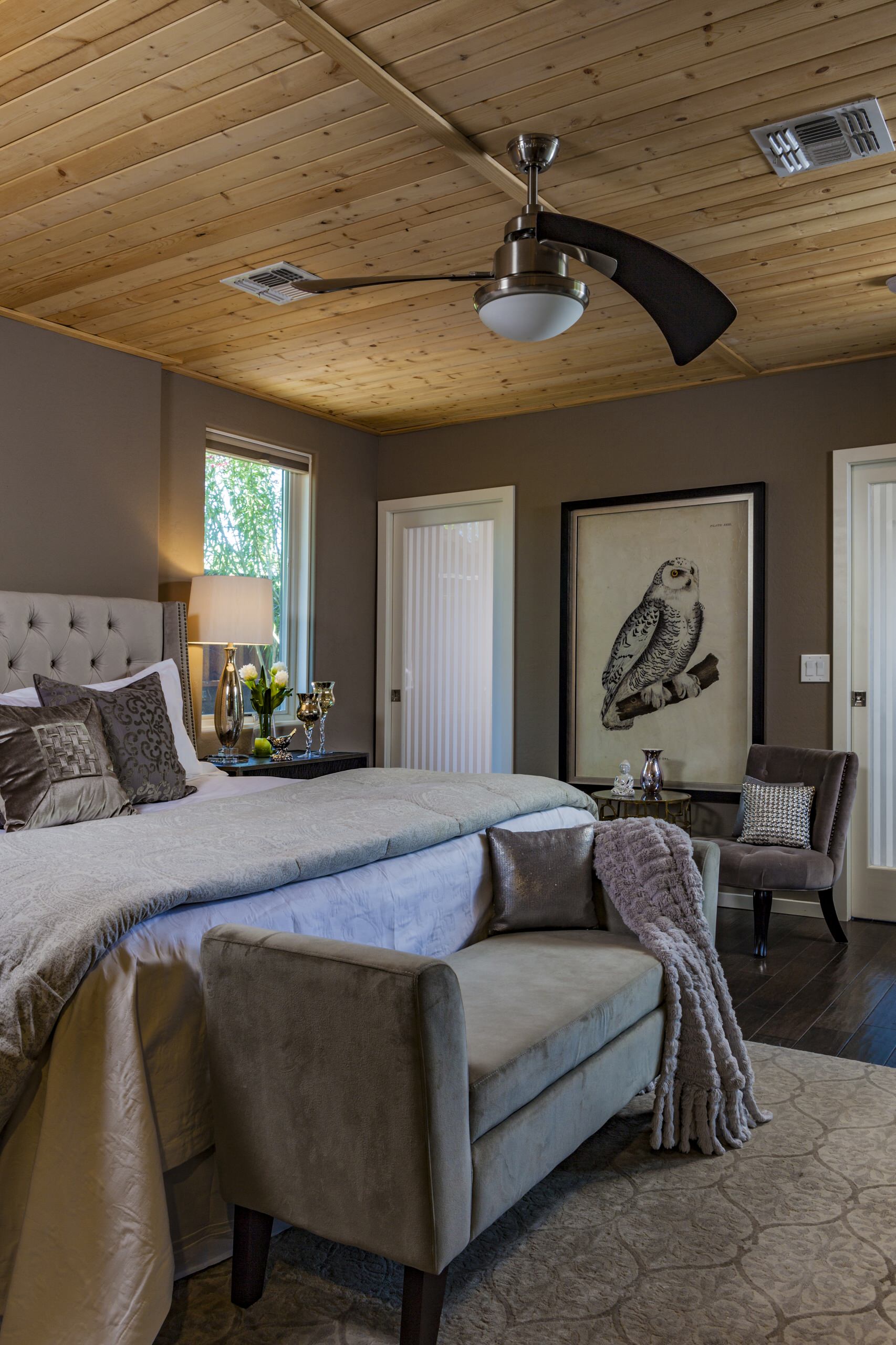 Mid-sized minimalist guest brown floor and dark wood floor bedroom photo in Phoenix with gray walls