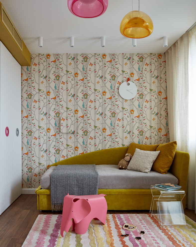 Design ideas for a mid-sized scandinavian kids' playroom for kids 4-10 years old and girls in Moscow with multi-coloured walls and medium hardwood floors.