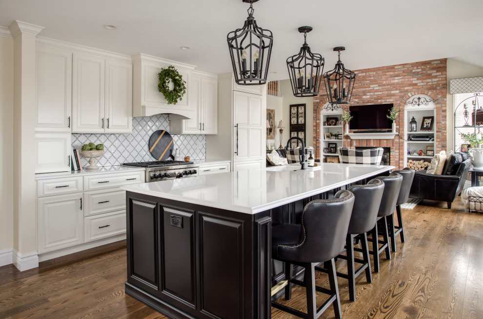 This is an example of a traditional kitchen in Denver with white cabinets, quartz benchtops, white splashback, ceramic splashback, panelled appliances, with island and white benchtop.