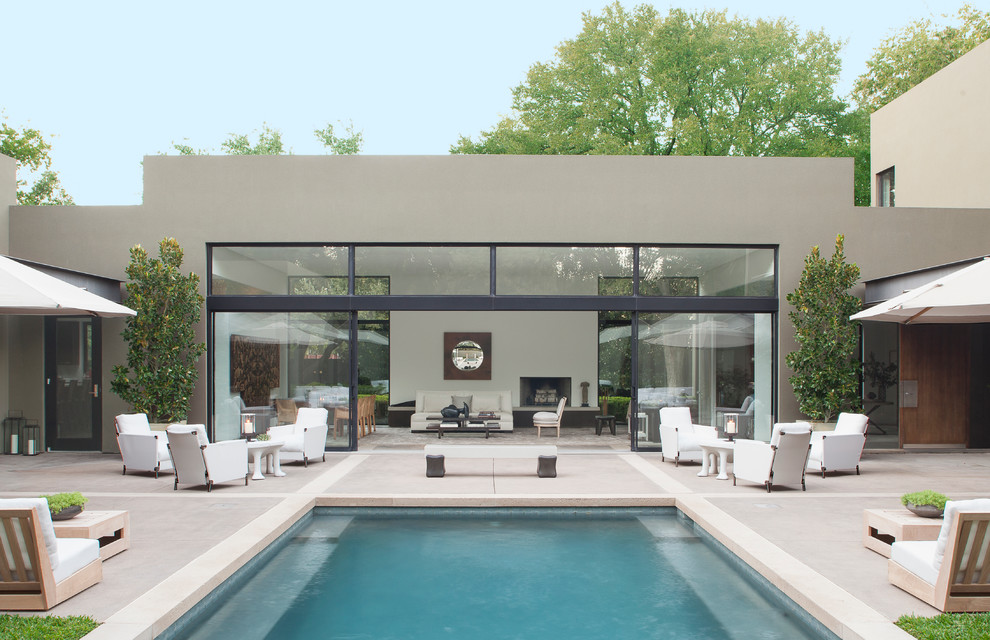 Photo of a contemporary courtyard rectangular pool in Dallas with concrete slab.