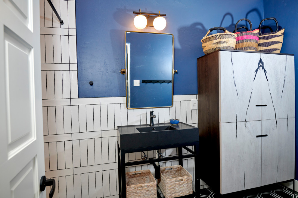 Bathroom - mid-sized transitional kids' blue tile and ceramic tile cement tile floor, black floor and single-sink bathroom idea in Denver with flat-panel cabinets, black cabinets, a one-piece toilet, blue walls, an undermount sink, granite countertops, black countertops, a niche and a freestanding vanity