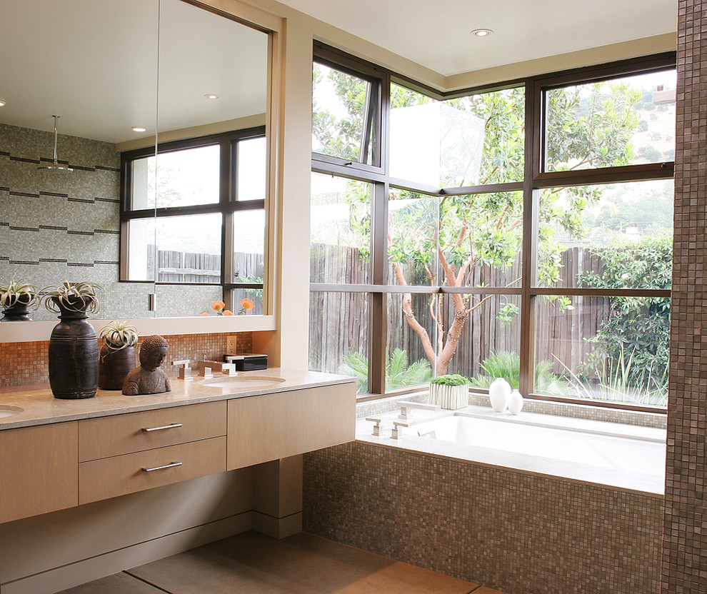 Photo of a large contemporary master bathroom in San Francisco with flat-panel cabinets, beige cabinets, an undermount tub, a curbless shower, multi-coloured tile, mosaic tile, beige walls, concrete floors, an undermount sink, marble benchtops and beige floor.