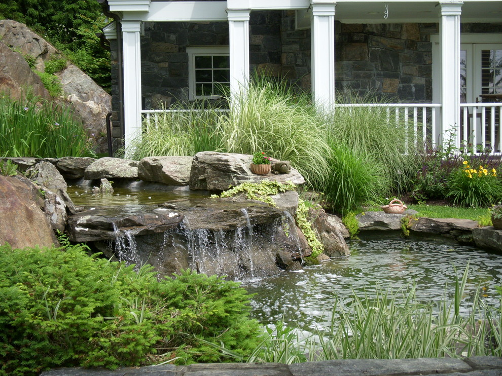 Traditional garden in New York with a water feature.
