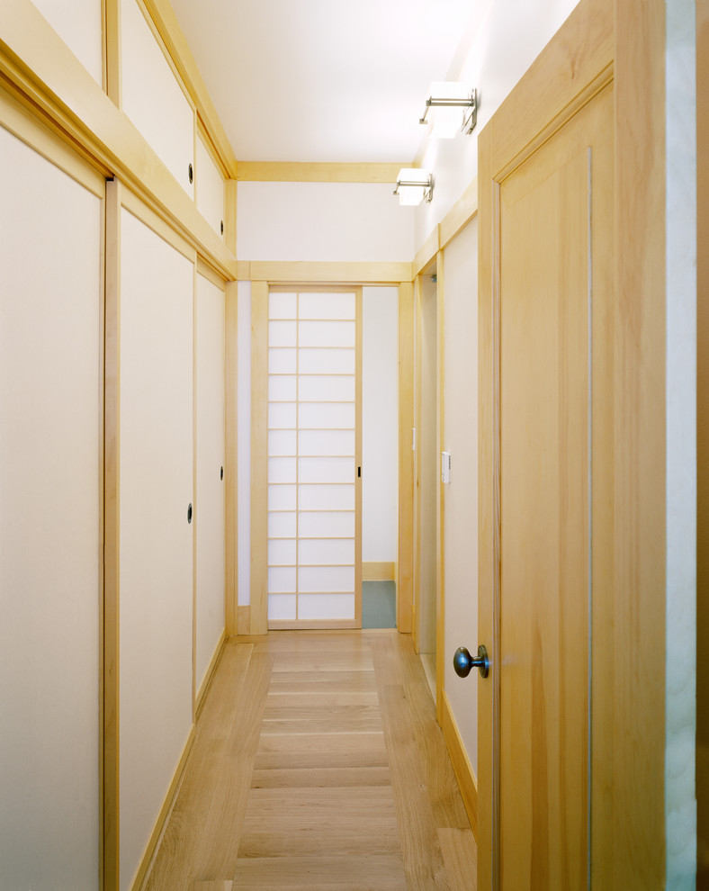 Small asian hallway in San Francisco with white walls and light hardwood floors.
