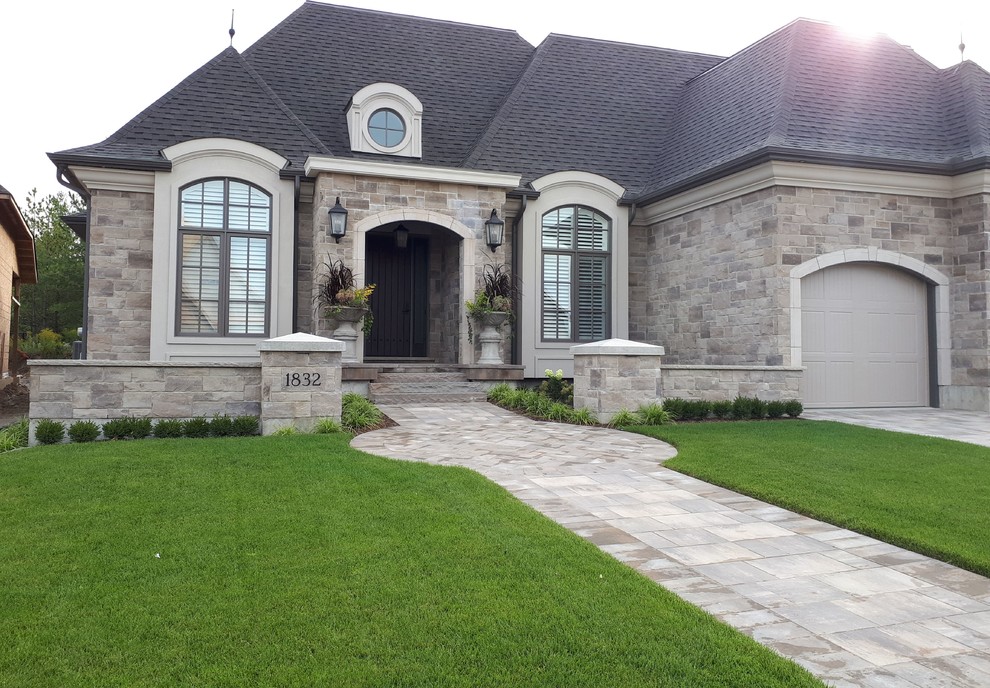 Design ideas for a mid-sized transitional front yard concrete paver formal garden.