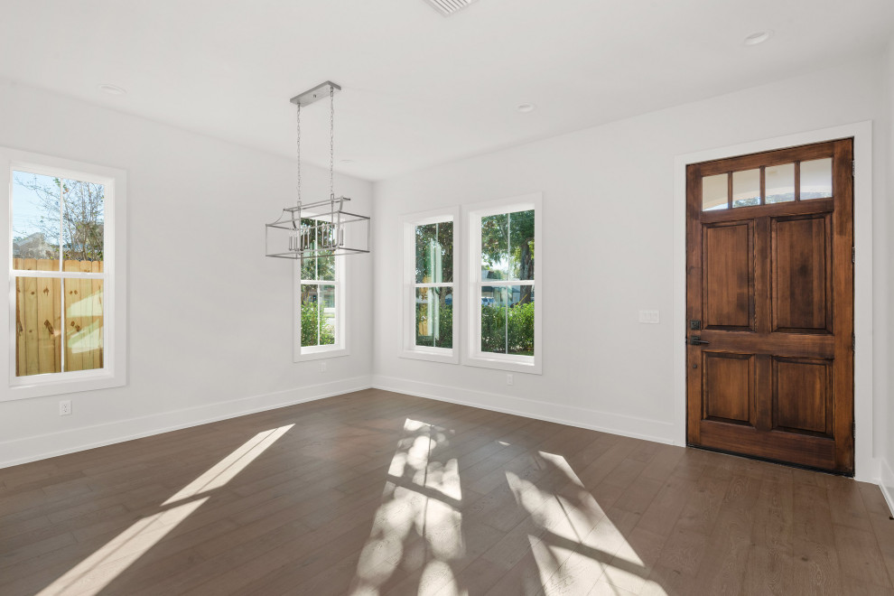 Transitional medium tone wood floor and brown floor front door photo in Orlando with white walls and a dark wood front door