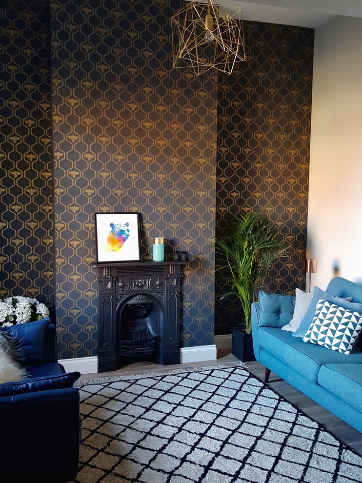 Mid-sized eclectic enclosed living room in Dublin with grey walls and a metal fireplace surround.