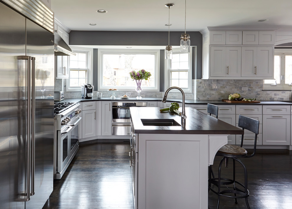 Example of a large transitional dark wood floor eat-in kitchen design in Chicago with a single-bowl sink, shaker cabinets, white cabinets, quartz countertops, white backsplash, stone tile backsplash, stainless steel appliances and two islands