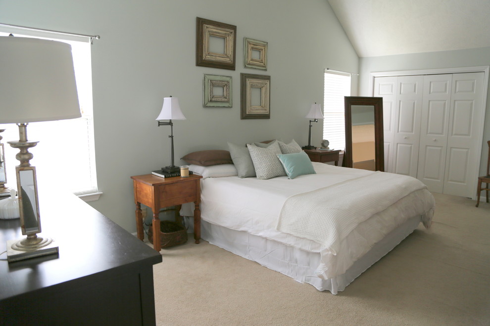 This is an example of a contemporary master bedroom in Nashville with blue walls and carpet.