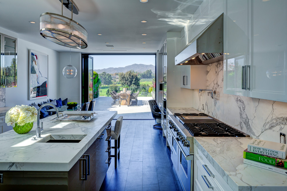 Design ideas for a large contemporary l-shaped eat-in kitchen in Los Angeles with a drop-in sink, shaker cabinets, white cabinets, marble benchtops, grey splashback, stone slab splashback, stainless steel appliances, dark hardwood floors and with island.