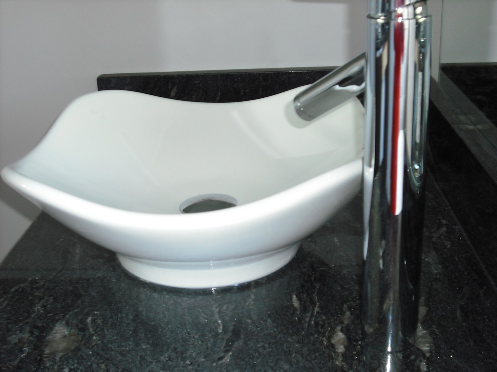 Large transitional master black and white tile and porcelain tile ceramic tile and single-sink freestanding bathtub photo in Baltimore with shaker cabinets, dark wood cabinets, a one-piece toilet, gray walls, a vessel sink, granite countertops, a hinged shower door and black countertops