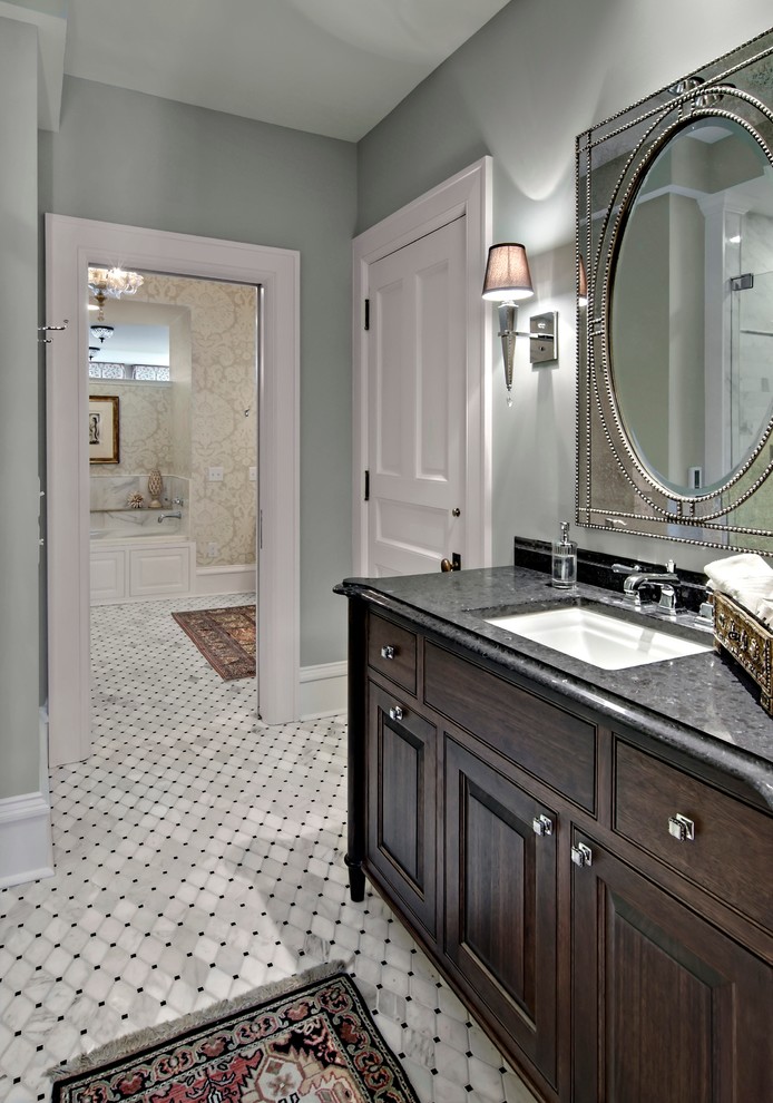 Design ideas for a mid-sized traditional 3/4 bathroom in Minneapolis with an undermount sink, furniture-like cabinets, dark wood cabinets, engineered quartz benchtops, gray tile, stone tile, grey walls and marble floors.