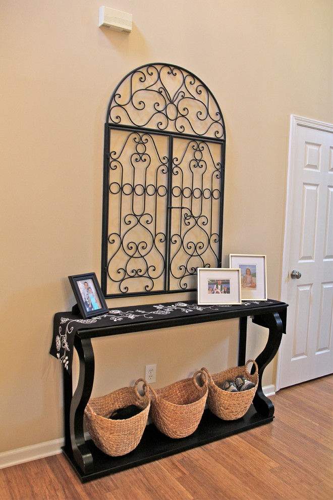 Photo of a small traditional foyer in Charlotte with a single front door, beige walls and bamboo floors.