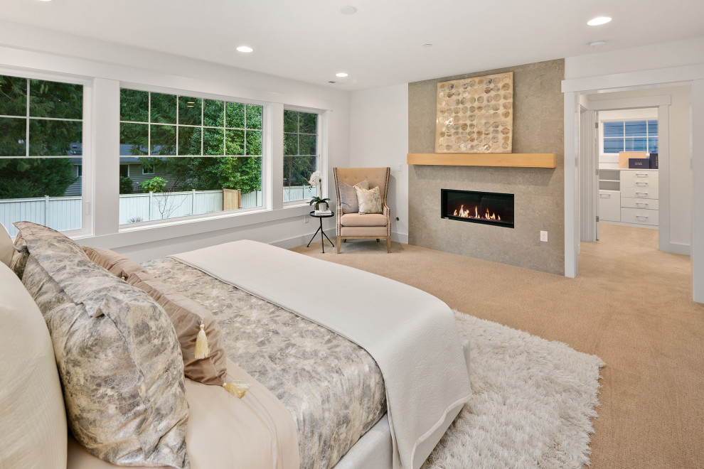 Large master bedroom in Seattle with white walls, carpet, a standard fireplace, a concrete fireplace surround and beige floor.