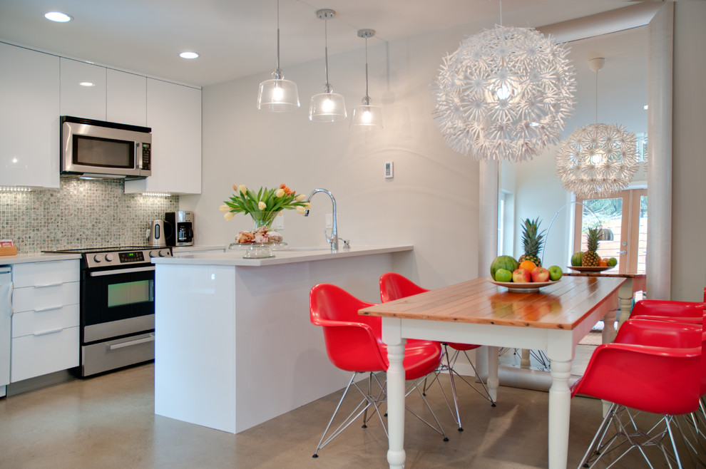 Photo of a contemporary eat-in kitchen in Vancouver with mosaic tile splashback, flat-panel cabinets, white cabinets and multi-coloured splashback.