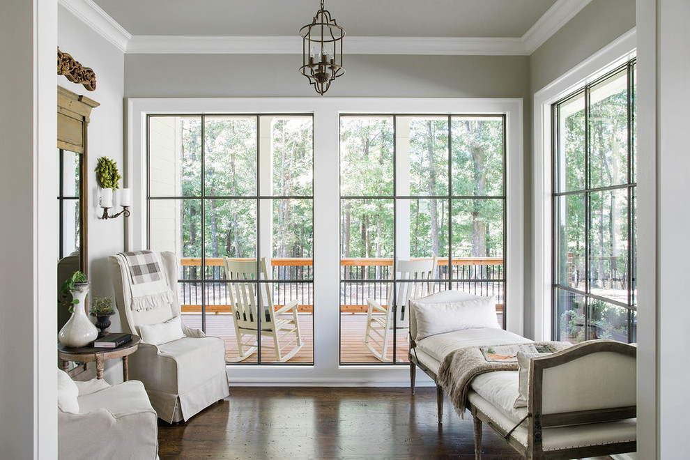 Country sunroom in Atlanta with laminate floors, a standard ceiling and brown floor.
