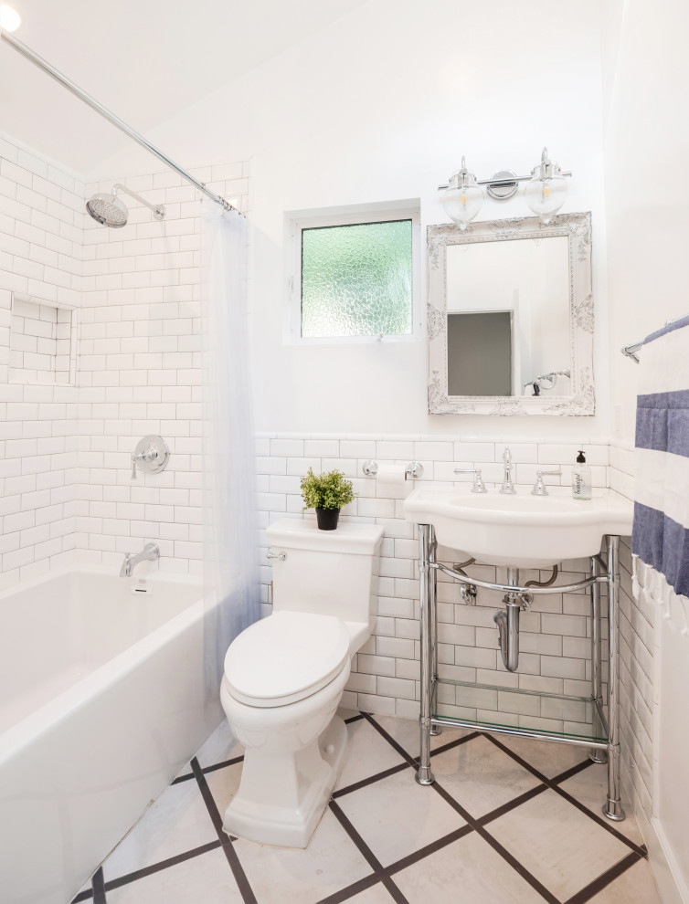 Design ideas for a transitional bathroom in Los Angeles with an alcove tub, a shower/bathtub combo, a one-piece toilet, white tile, subway tile, white walls, a console sink, grey floor, a shower curtain, a niche, a single vanity and vaulted.