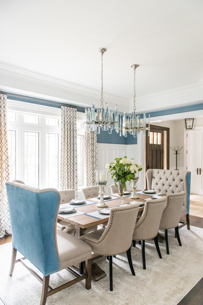 Example of a large transitional medium tone wood floor and brown floor enclosed dining room design in Toronto with blue walls and no fireplace