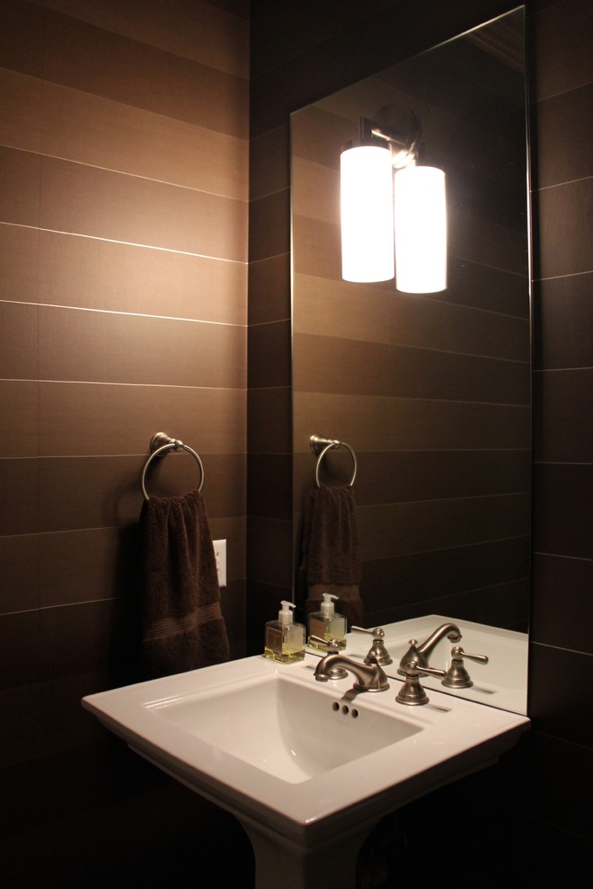 Photo of a small contemporary powder room in Grand Rapids with brown walls, a pedestal sink and brown tile.