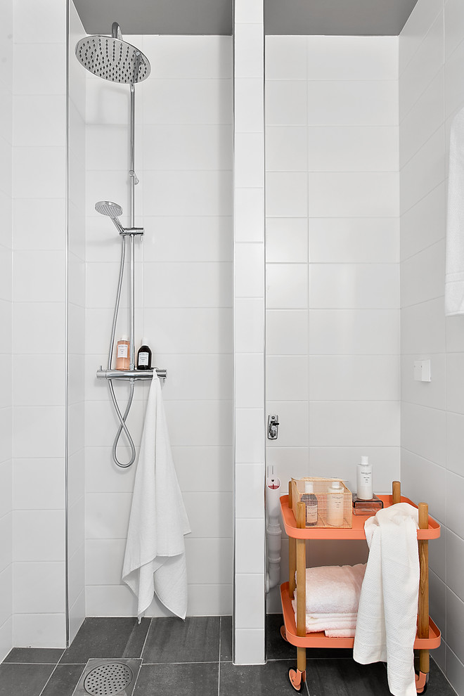 Photo of a small scandinavian bathroom in Stockholm with an open shower, white tile, orange cabinets, ceramic tile, white walls, limestone floors and an open shower.