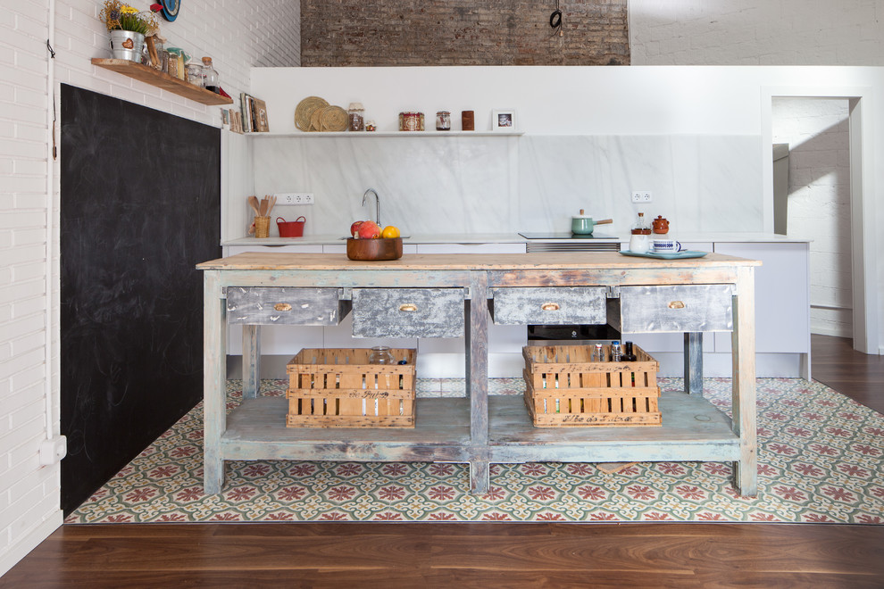Inspiration for an industrial single-wall kitchen in Barcelona with with island.