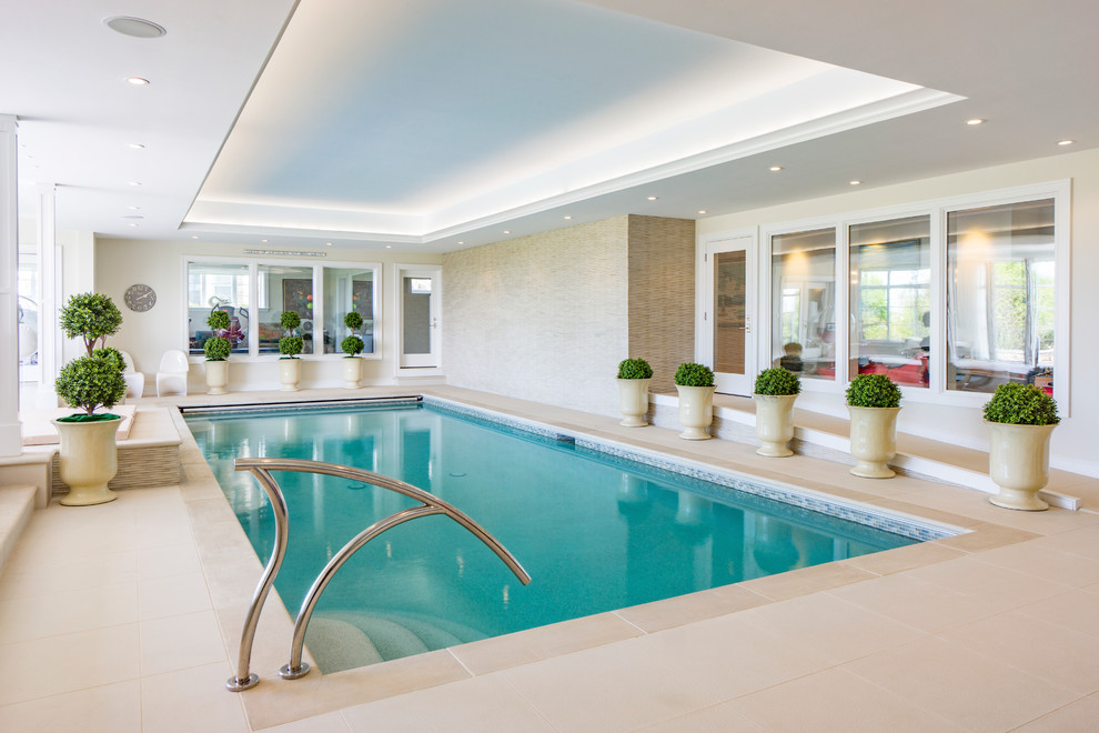 Traditional indoor rectangular pool in Boston with tile.