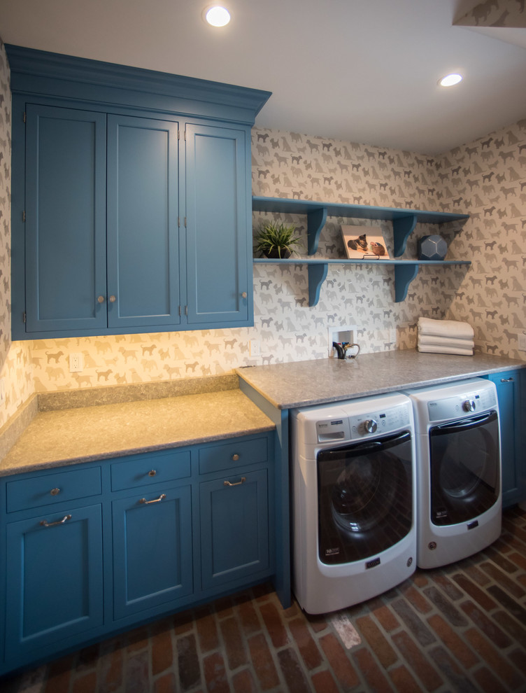 Country laundry room in Philadelphia with an undermount sink, blue cabinets, quartz benchtops, brick floors, a side-by-side washer and dryer and beige benchtop.