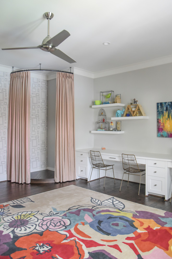 This is an example of a transitional kids' playroom for kids 4-10 years old and girls in Houston with grey walls, medium hardwood floors, brown floor and wallpaper.