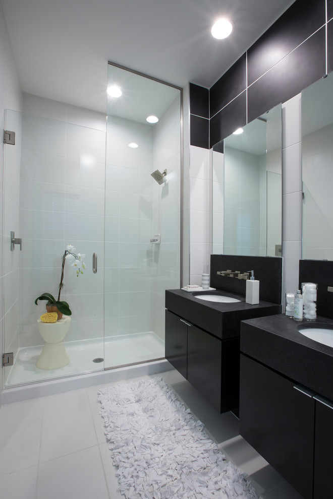 Inspiration for a contemporary bathroom in Orlando with flat-panel cabinets, black cabinets and an alcove shower.