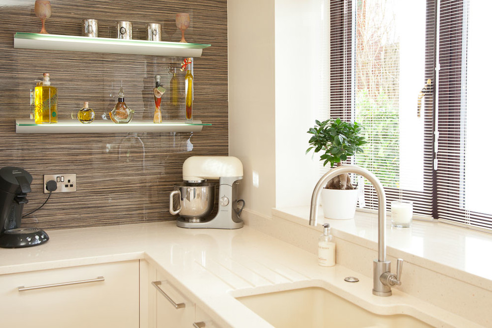 This is an example of a large contemporary kitchen/diner with an integrated sink, flat-panel cabinets, quartz worktops, stainless steel appliances, vinyl flooring and multiple islands.