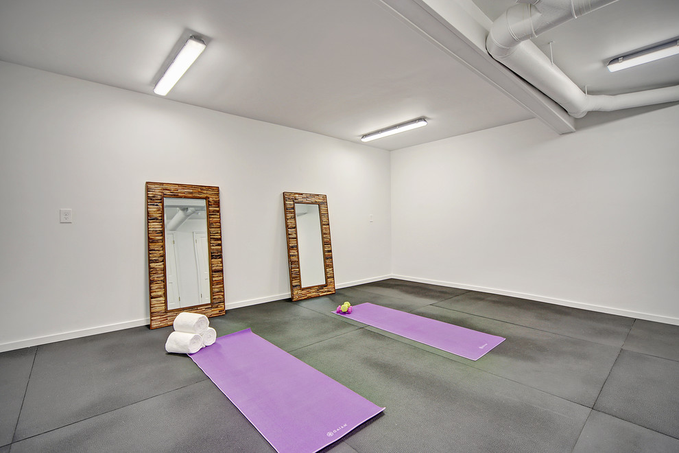 This is an example of a mid-sized midcentury home yoga studio in Seattle with grey walls and black floor.