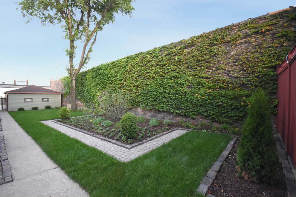 This is an example of a mid-sized country courtyard full sun formal garden for summer in Chicago with with lawn edging and brick pavers.