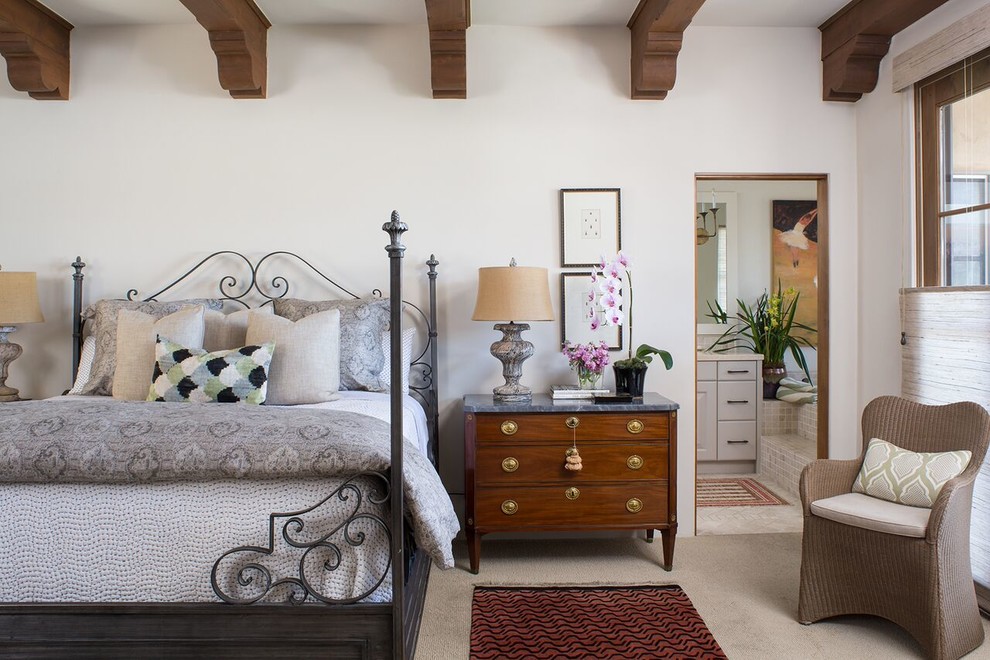 Inspiration for a mid-sized mediterranean master bedroom in Santa Barbara with white walls and carpet.