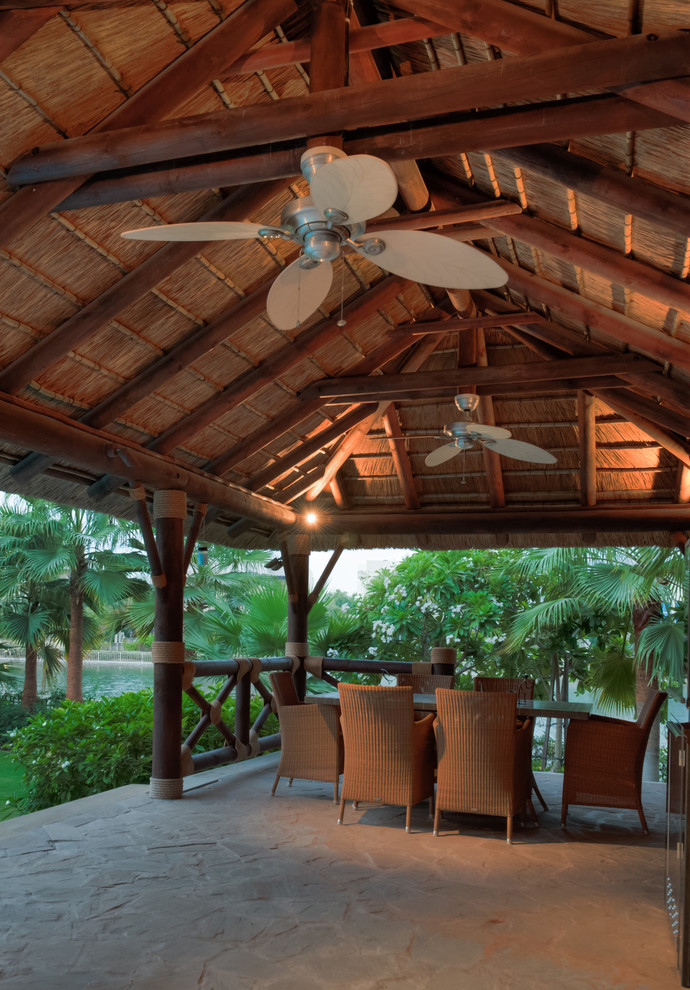Inspiration for a mediterranean patio in Miami with a roof extension.