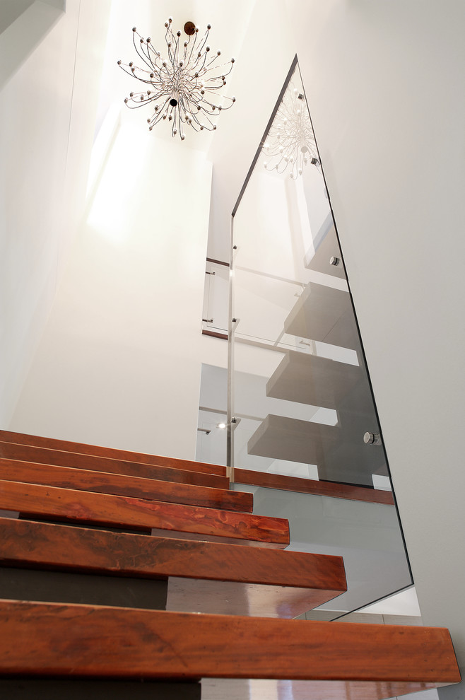 Mid-sized contemporary wood floating staircase in Brisbane with wood risers.