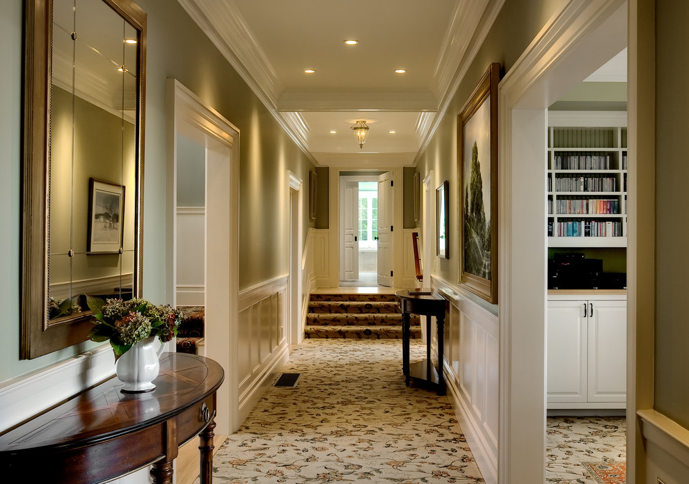 Traditional hallway in New York with green walls and carpet.