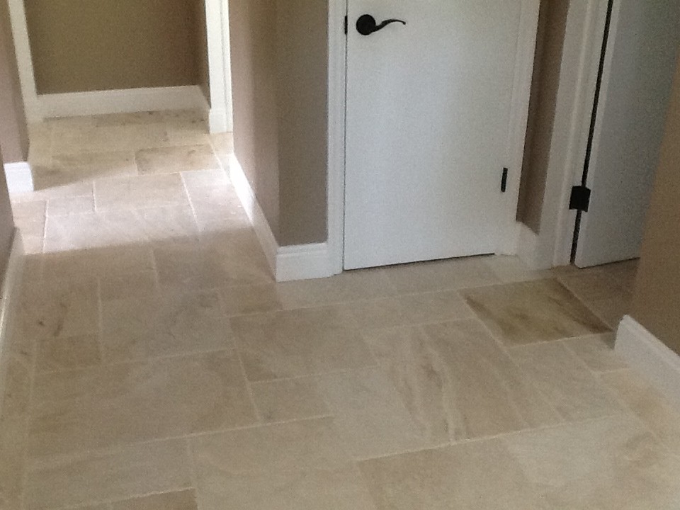 Inspiration for a mid-sized modern travertine floor hallway remodel in Tampa with beige walls