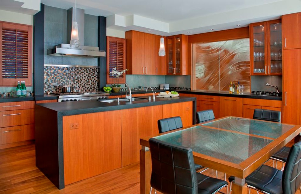 This is an example of a contemporary u-shaped eat-in kitchen in San Diego with a double-bowl sink, flat-panel cabinets, medium wood cabinets, multi-coloured splashback, granite benchtops, glass tile splashback, medium hardwood floors and with island.